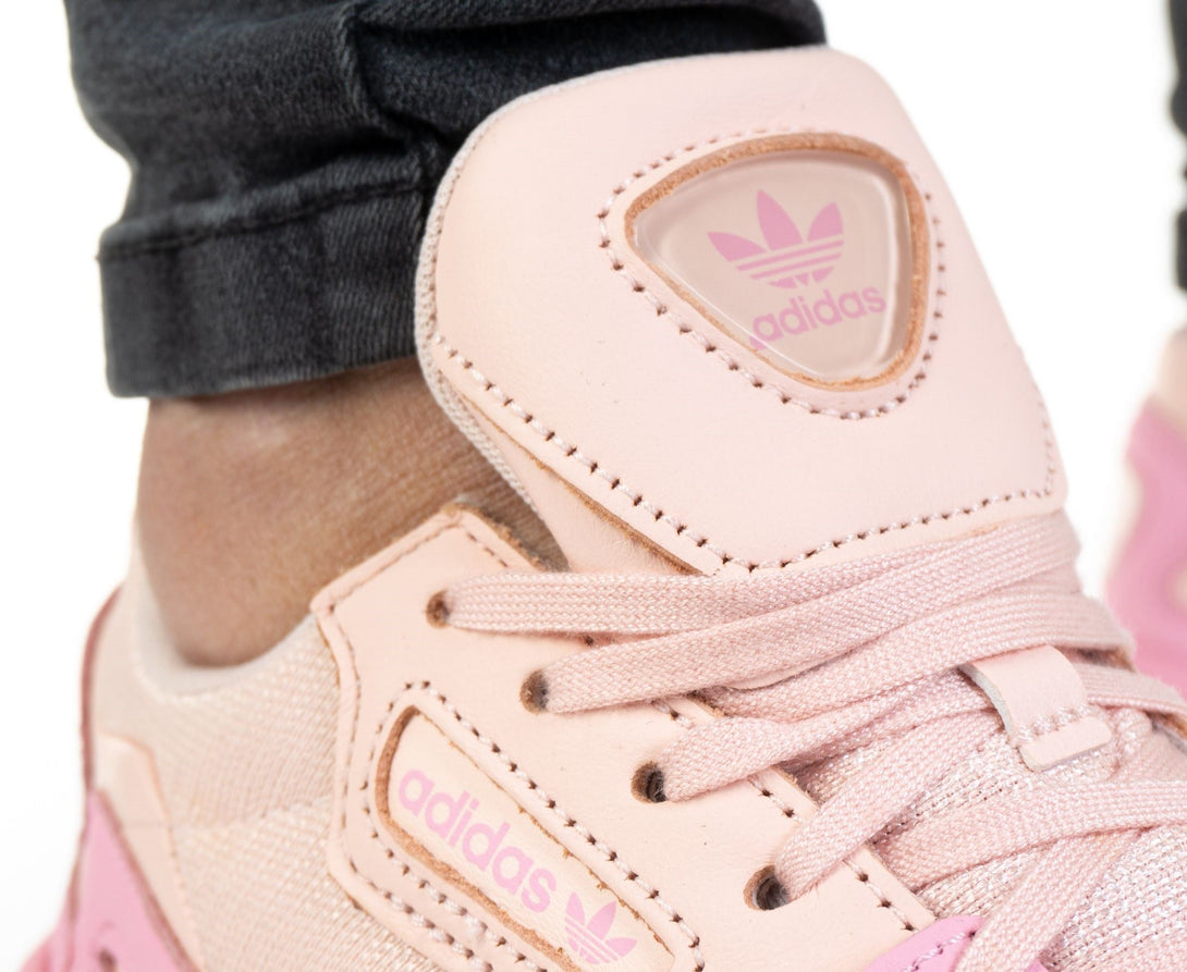 adidas FALCON Women EF1994 close-up of stylish pink sneaker with logo and laces.